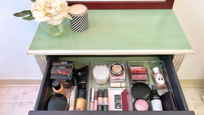 drawer open showing makeup organization using bins